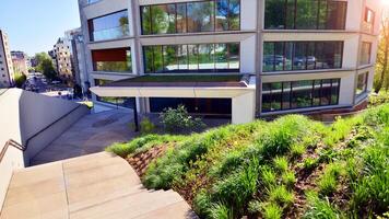 Eco architecture. Green tree and new residential building. Harmony of nature and modernity. Modern apartment building with new apartments in a green residential area. photo