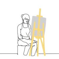 female artist sits at an easel with a brush in her hand, peering at the canvas in front of her - one line art . concept of thoughtfulness in the process of painting a picture vector