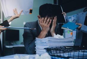 Stressful business man have so many paperwork in the office photo