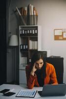 Portrait of tired young business Asian woman work with documents tax laptop computer in office. Sad, unhappy, Worried, Depression, or employee life stress concept photo