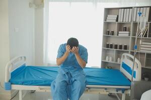 A male patient suffering from stress, migraines, eye strain, headaches, eye problems from working hard and not getting enough rest receives treatment from a doctor at the hospital. photo