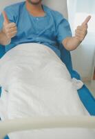 Portrait of happy caucasian sick patient on bed in hospital in medical and healthcare treatment at nursing home or clinic. People lifestyle photo