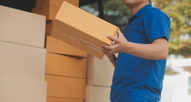 Asian delivery express courier young man use giving boxes to woman customer he wearing protective face mask at front home photo