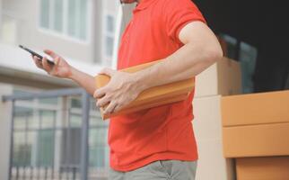 Asian delivery express courier young man use giving boxes to woman customer he wearing protective face mask at front home photo