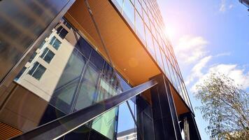 Steel and glass. The subject of modern architecture or construction industry. Modern office building facade with tall steel construction elements and full height windows between. photo