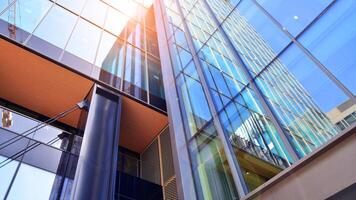 Steel and glass. The subject of modern architecture or construction industry. Modern office building facade with tall steel construction elements and full height windows between. photo