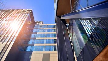 Steel and glass. The subject of modern architecture or construction industry. Modern office building facade with tall steel construction elements and full height windows between. photo