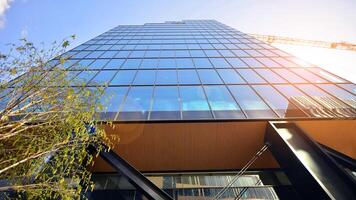 Steel and glass. The subject of modern architecture or construction industry. Modern office building facade with tall steel construction elements and full height windows between. photo