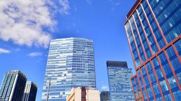 Glass building with transparent facade of the building and blue sky. Structural glass wall reflecting blue sky. Abstract modern architecture fragment. Contemporary architectural background. photo