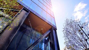 Steel and glass. The subject of modern architecture or construction industry. Modern office building facade with tall steel construction elements and full height windows between. photo