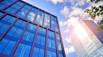 Glass building with transparent facade of the building and blue sky. Structural glass wall reflecting blue sky. Abstract modern architecture fragment. Contemporary architectural background. photo