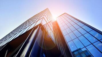 Steel and glass. The subject of modern architecture or construction industry. Modern office building facade with tall steel construction elements and full height windows between. photo