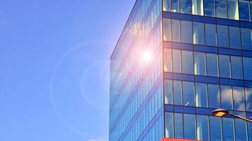 Glass building with transparent facade of the building and blue sky. Structural glass wall reflecting blue sky. Abstract modern architecture fragment. Contemporary architectural background. photo