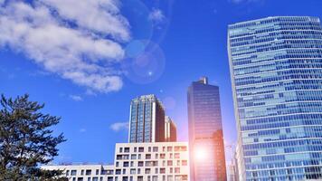 Glass building with transparent facade of the building and blue sky. Structural glass wall reflecting blue sky. Abstract modern architecture fragment. Contemporary architectural background. photo