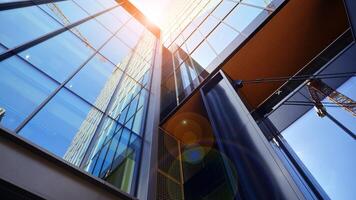 Steel and glass. The subject of modern architecture or construction industry. Modern office building facade with tall steel construction elements and full height windows between. photo