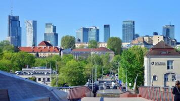 Warsaw, Poland. 11 April 2024. Bridge over the Vistula River intended only for pedestrians and cyclists. In the background, a panorama of the city with skyscrapers. photo