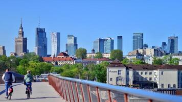 Warsaw, Poland. 11 April 2024. Bridge over the Vistula River intended only for pedestrians and cyclists. In the background, a panorama of the city with skyscrapers. photo