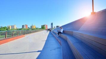 Warsaw, Poland. 11 April 2024. Bridge over the Vistula River intended only for pedestrians and cyclists. In the background, a panorama of the city on the right bank of the Vistula. photo