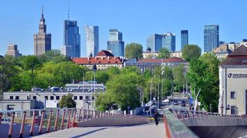 Warsaw, Poland. 11 April 2024. Bridge over the Vistula River intended only for pedestrians and cyclists. In the background, a panorama of the city with skyscrapers. photo