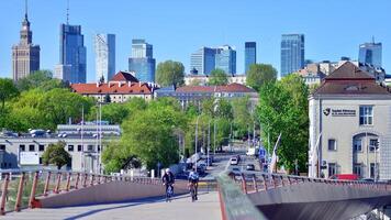 Warsaw, Poland. 11 April 2024. Bridge over the Vistula River intended only for pedestrians and cyclists. In the background, a panorama of the city with skyscrapers. photo