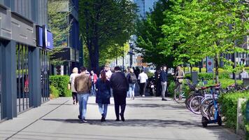 Warsaw, Poland. 11 April 2024. People of different ages and nationalities walk across in the city center, spring time. People at the street. photo