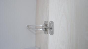 Women's hands are locked. Lock the white door in the hotel for your own safety. Security concept. video