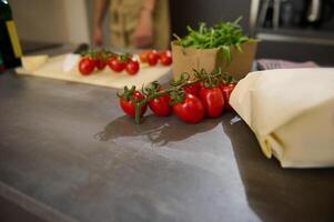 A bunch of tomato cherry on the kitchen counter. photo