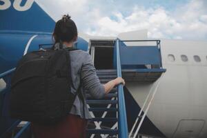 Happy attractive asian woman traveler with backpack at the modern airport terminal, copy space, Tourist journey trip concept photo