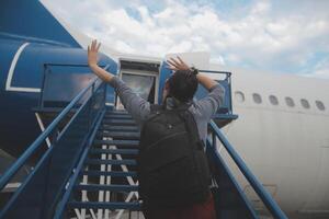 Happy attractive asian woman traveler with backpack at the modern airport terminal, copy space, Tourist journey trip concept photo