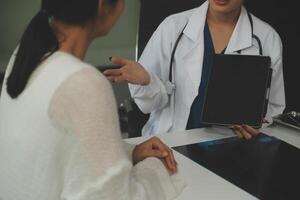 Charming female doctor giving advice to a female patient. photo