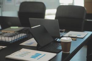 Laptop on a desk in an open financial office. photo