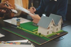 Team of architectures and businessmen discussing and brainstorming on floor plan modification for real estate investment and housing development project photo