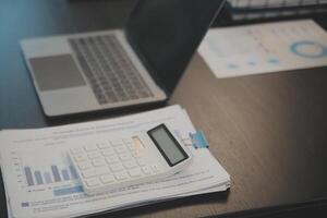 Laptop on a desk in an open financial office. photo