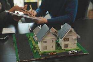 Team of architectures and businessmen discussing and brainstorming on floor plan modification for real estate investment and housing development project photo