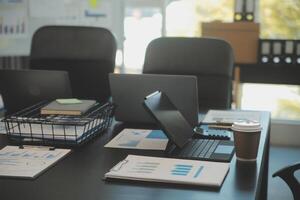 Laptop on a desk in an open financial office. photo