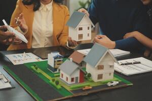 Team of architectures and businessmen discussing and brainstorming on floor plan modification for real estate investment and housing development project photo