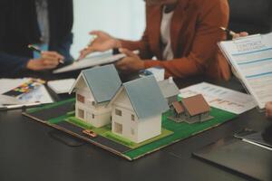 Team of architectures and businessmen discussing and brainstorming on floor plan modification for real estate investment and housing development project photo
