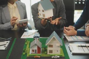 Team of architectures and businessmen discussing and brainstorming on floor plan modification for real estate investment and housing development project photo