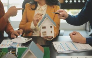 Team of architectures and businessmen discussing and brainstorming on floor plan modification for real estate investment and housing development project photo
