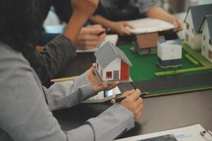 Team of architectures and businessmen discussing and brainstorming on floor plan modification for real estate investment and housing development project photo