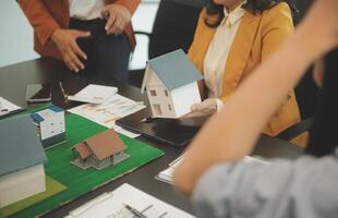 Team of architectures and businessmen discussing and brainstorming on floor plan modification for real estate investment and housing development project photo