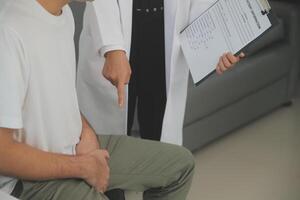 Male diseases. Man presses hands to his groin and suffering from pain, panorama, cropped, studio shot photo