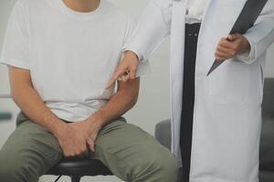 Male diseases. Man presses hands to his groin and suffering from pain, panorama, cropped, studio shot photo