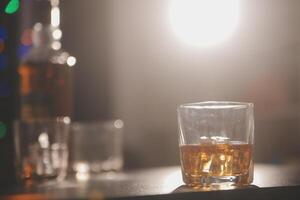 Celebration night, pour whiskey into a glass. Give to friends who come to celebrate photo