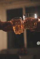 Celebration night, pour whiskey into a glass. Give to friends who come to celebrate photo