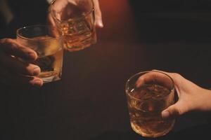 Celebration night, pour whiskey into a glass. Give to friends who come to celebrate photo