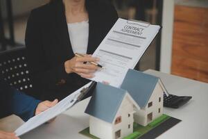 Business Signing a Contract Buy - sell house, insurance agent analyzing about home investment loan Real Estate concept. photo