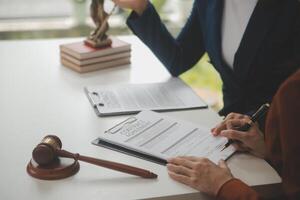 Lawyer, legal advisor, businessman brainstorming information on agreement details Business contracts in legal processing books for accuracy in contract documents. joint financial investment. photo