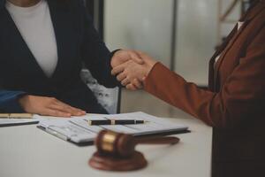 Lawyer, legal advisor, businessman brainstorming information on agreement details Business contracts in legal processing books for accuracy in contract documents. joint financial investment. photo