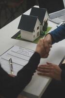 Business Signing a Contract Buy - sell house, insurance agent analyzing about home investment loan Real Estate concept. photo